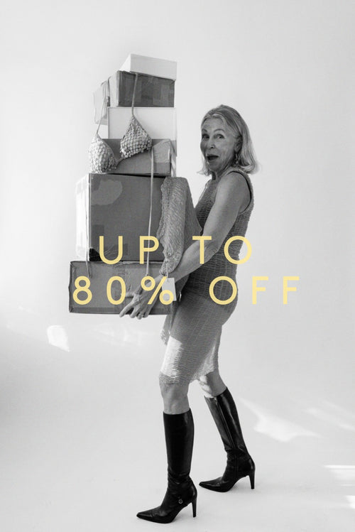 Hanne carrying a stack of moving boxes, up to 80% off